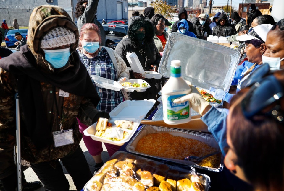 <strong>People receive a free hot meal during Young Dolph&rsquo;s IdaMae Family Foundation and Confess Project of America free giveaway event on Thursday, Nov. 17, 2022 at The Hub.</strong> (Mark Weber/The Daily Memphian)