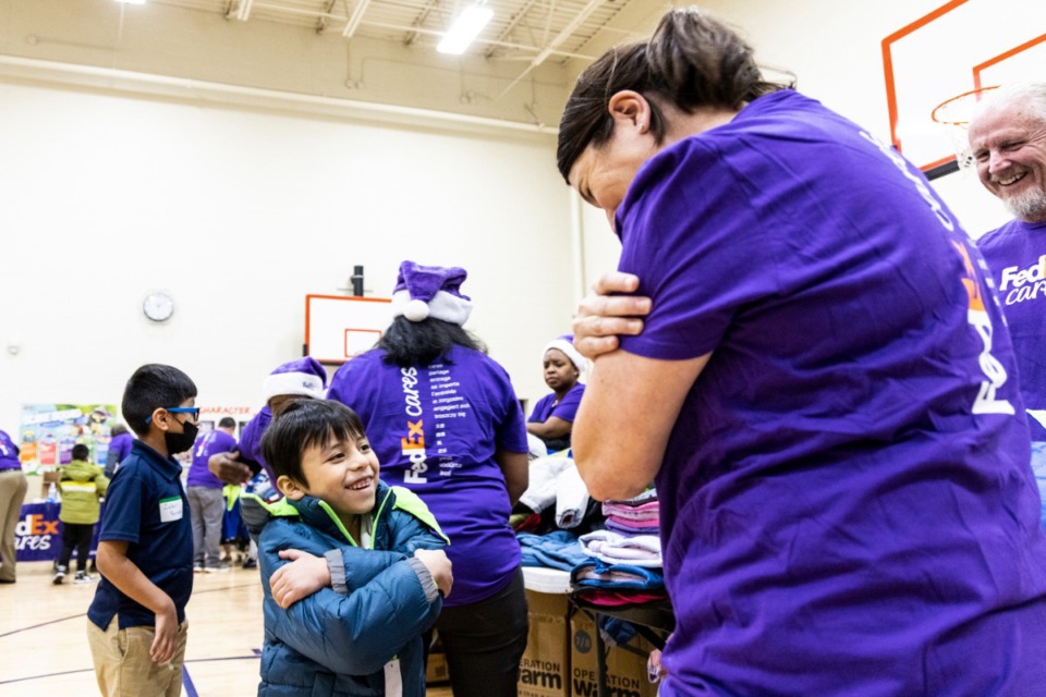 <strong>Luis Almazan tried on a new winter coat at Wells Station Elementary school on Tuesday. FedEx Cares provided nearly 700 new winter coats to Wells Station students children in need at Wells Station Elementary through its collaboration with Operation Warm.</strong> (Brad Vest/Special to The Daily Memphian)