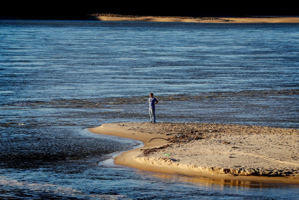 <strong>A person stands on a sandbar while checking out the historically low water levels of the Mississippi River on Wednesday, Oct. 26, 2022 in Greenbelt Park.</strong> (Mark Weber/The Daily Memphian)