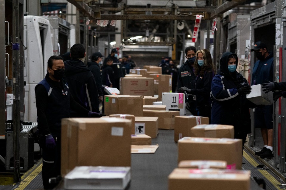 <strong>Employees sort packages for delivery at the FedEx regional hub at the Los Angeles International Airport in Los Angeles, Tuesday, Dec. 7, 2021.</strong> (AP Photo/Jae C. Hong, File)