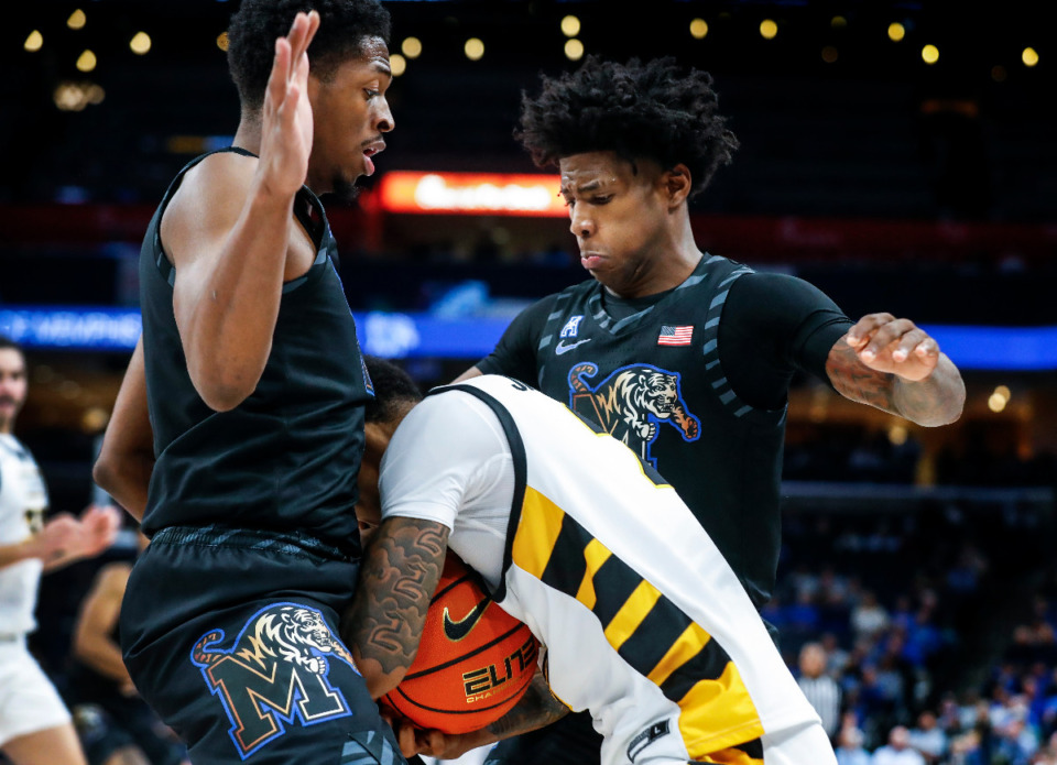 <strong>Memphis Tigers defenders Elijah McCadden (left) and Kendric Davis (right) apply pressure to VCU guard Adrian Baldwin Jr. (middle) during action on Sunday, Nov. 20, 2022.</strong> (Mark Weber/The Daily Memphian)