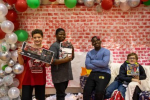<strong>A group of kids show the presents they received through Youth Villages&rsquo; Holiday Heroes program.</strong> (Courtesy Youth Vilages)