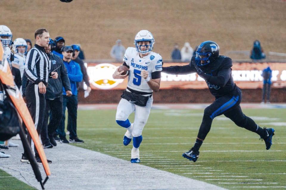 <strong>Tigers quarterback Seth Henigan runs out of bounds during the Saturday, Nov. 26 game between the Memphis Tigers and the SMU Mustangs at Gerald J. Ford Stadium in Dallas.</strong> (Courtesy Memphis Athletics)