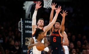 <strong>Memphis Grizzlies guard Ja Morant, with the ball, is defended by New York Knicks center Isaiah Hartenstein, left, and guard Quentin Grimes (6) during the first half of an NBA basketball game, Sunday, Nov. 27, 2022, in New York.</strong> (John Munson/AP)