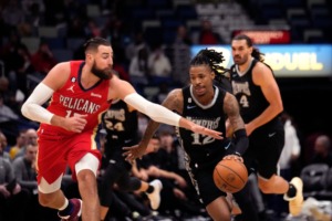 <strong>With Steven Adams covering his back, Memphis Grizzlies guard Ja Morant (12) moves the ball down court past New Orleans Pelicans center Jonas Valanciunas in the first half of an NBA basketball game in New Orleans, Tuesday, Nov. 15, 2022.</strong> (Gerald Herbert/AP file)