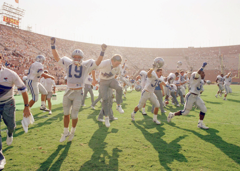 <strong>Jeremy Williams (19) and his Memphis State University teammates celebrate their 24-10 upset victory over Southern California at the Coliseum in Los Angeles, Sept. 2, 1991. Chuck Stobart was the Tigers coach when Memphis pulled off this upset in 1991.</strong> (AP File Photo/Craig Fujii)