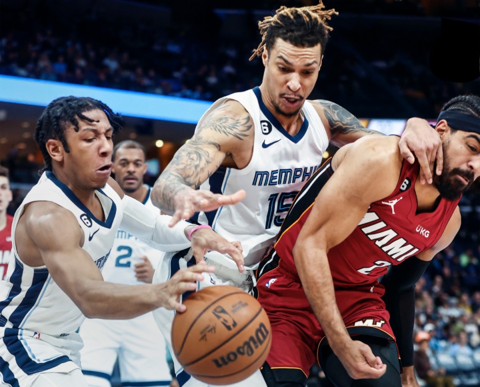 <strong>Memphis Grizzlies teammates Kennedy Chandler (left) and Brandon Clarke (middle) battle Miami Heat defender Gabe Vincent (right) for a rebound on Monday, Dec. 5, 2022.</strong> (Mark Weber/The Daily Memphian)