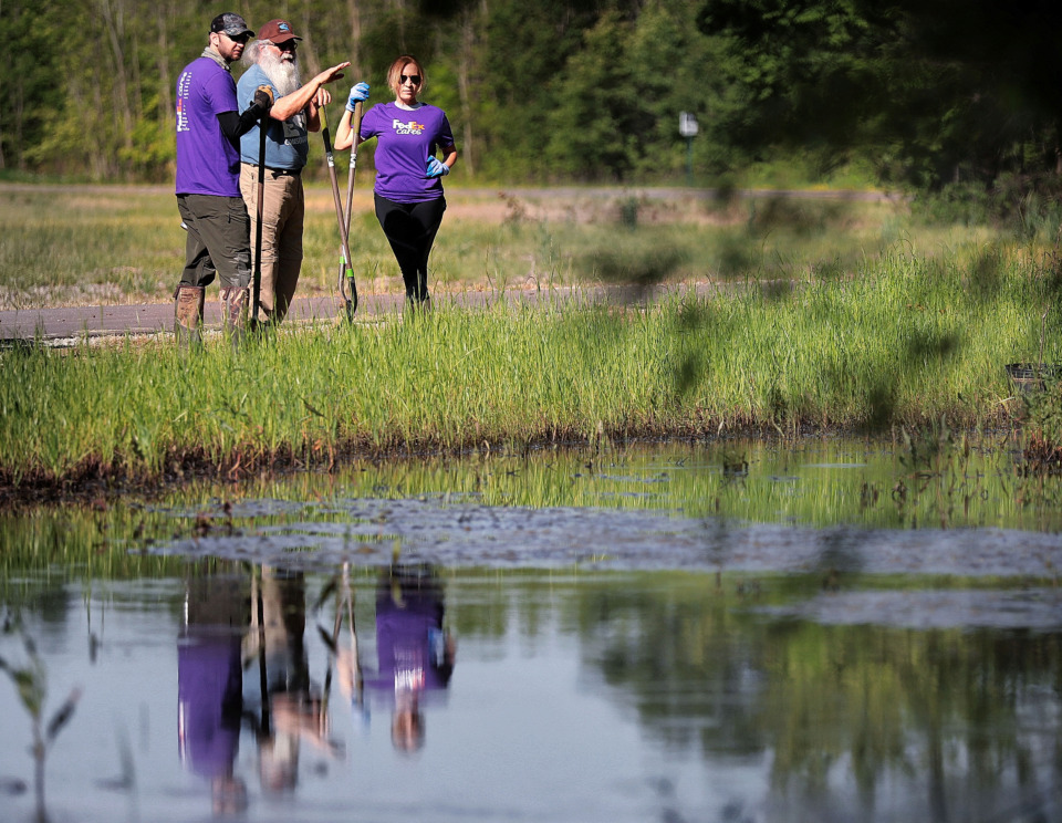 <strong>FedEx volunteers Neal Edwards (left) and Chelsea Mullen make a plan for tree planting with Jim Gafford (center) from the Wolf River Conservancy as groups of volunteers help spruce up a new section of the Wolf River Greenway in Raleigh on April 24, 2019.</strong> (Jim Weber/Daily Memphian)