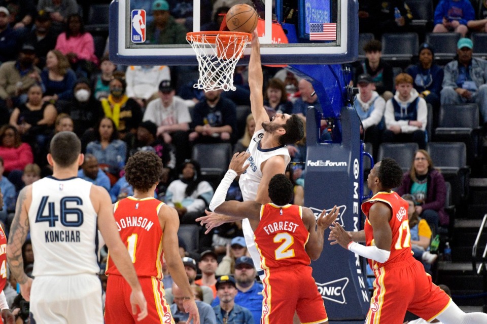<strong>Memphis Grizzlies forward Santi Aldama, center top, goes up to dunk against Atlanta Hawks guard Trent Forrest (2) on Dec. 12, 2022.</strong> (Brandon Dill/AP)