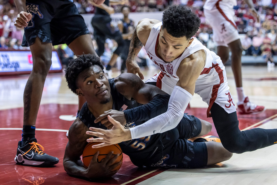 <strong>Memphis guard Damaria Franklin (55) and Alabama guard Jahvon Quinerly (5) chase a loose ball during the second half of an NCAA college basketball game, Tuesday, Dec. 13, 2022, in Tuscaloosa, Ala.</strong> (AP Photo/Vasha Hunt)