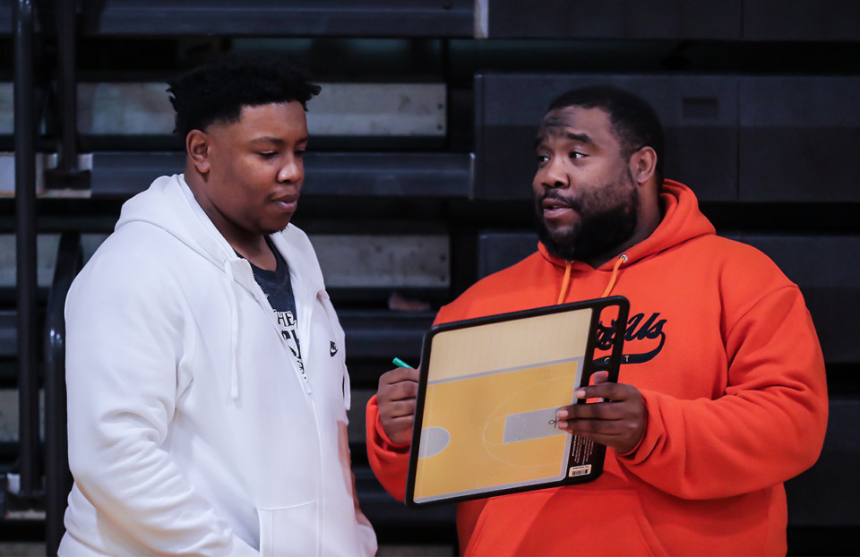 <strong>Coaches Jarvis Jones (left) and Dee Jones go over plays during a practice at Mitchell High School. Jarvis Jones&nbsp;played at Mitchell from 2004 to 2008 and was a part of three state-tournament teams.</strong> (Patrick Lantrip/The Daily Memphian)