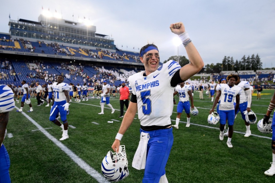 <strong>Memphis quarterback Seth Henigan (5) pumps his fist toward the stands after an NCAA college football game against Navy, Saturday, Sept. 10, 2022, in Annapolis, Md.</strong> (AP Photo/Nick Wass)