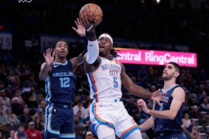 <strong>Oklahoma City Thunder guard Luguentz Dort (5) goes to the basket between Memphis Grizzlies guard Ja Morant (12) and forward Santi Aldama (7) in the first half of an NBA basketball game Saturday, Dec. 17, 2022, in Oklahoma City.</strong> (Sue Ogrocki/AP)