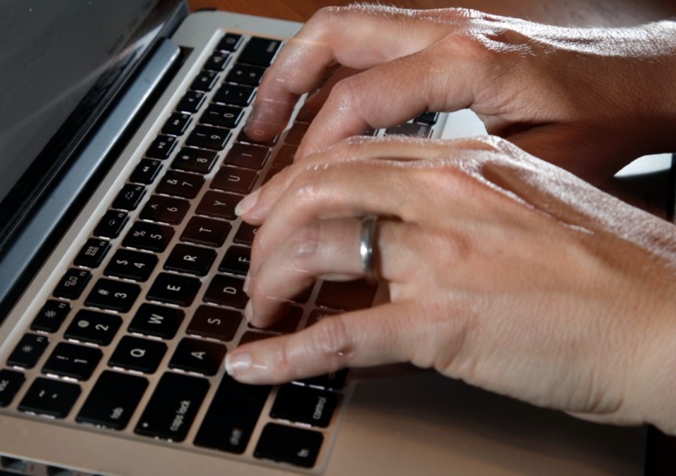 In this Monday, June 19, 2017, photo, a person types on a laptop keyboard, in North Andover, Mass. One of the nation&rsquo;s biggest telemedicine providers is spending more than $18 billion to stoke an approach to care that grew explosively during the pandemic. Teladoc Health plans to dive deep into managing the health of patients with diabetes and high blood pressure with a cash-and-stock deal for Livongo Health. Telemedicine involves care delivered remotely, often with a live video connection through patient smartphones or tablets. (AP Photo/Elise Amendola)