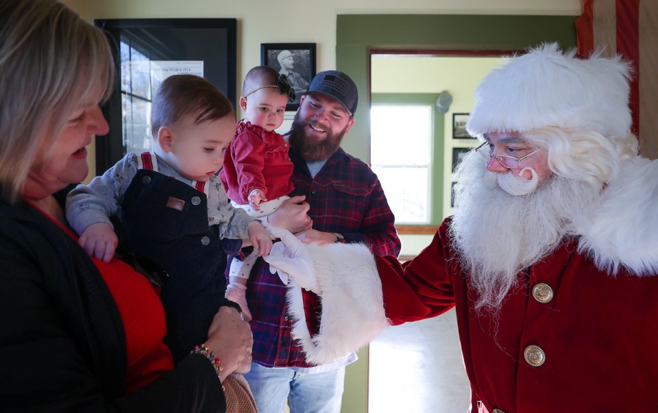 <strong>Official Germantown Santa Justin Duncan tries to win over twins Wyatt and Annie Kate Dugard at the Germantown Depot Museum Dec. 17, 2022.</strong> (Patrick Lantrip/The Daily Memphian)