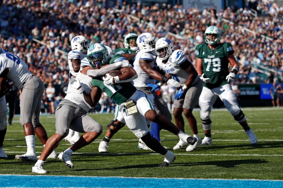 <strong>Tulane running back Shaadie Clayton (0) breaks free from Memphis linebacker Geoffrey Cantin-Arku (9) to score a touchdown during the first half of an NCAA college football game in New Orleans, Saturday, Oct. 22, 2022.</strong> (AP Photo/Tyler Kaufman)