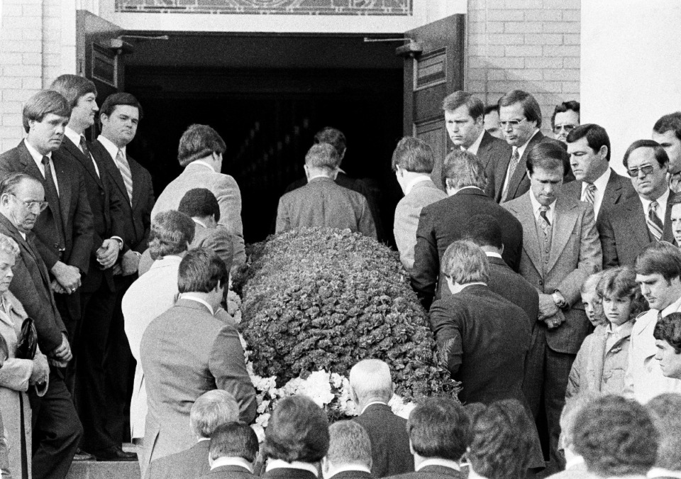 <strong>The casket of Alabama football coach Paul "Bear" Bryant, covered with flowers, is carried into the First Methodist Church in Tuscaloosa, Ala., Jan. 28, 1983. Pallbearers are eight members of his 1982 football team.</strong>&nbsp;(AP File Photo)