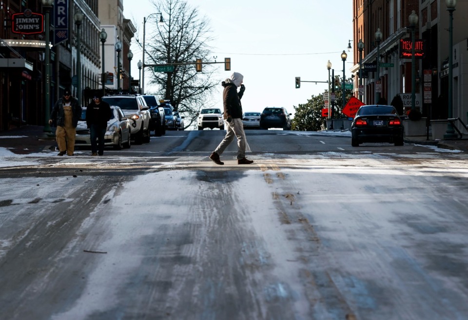 <strong>A man braves the blistering cold temperatures and icy conditions while walking downtown on Friday, Dec. 23, 2022.</strong> (Mark Weber/The Daily Memphian)