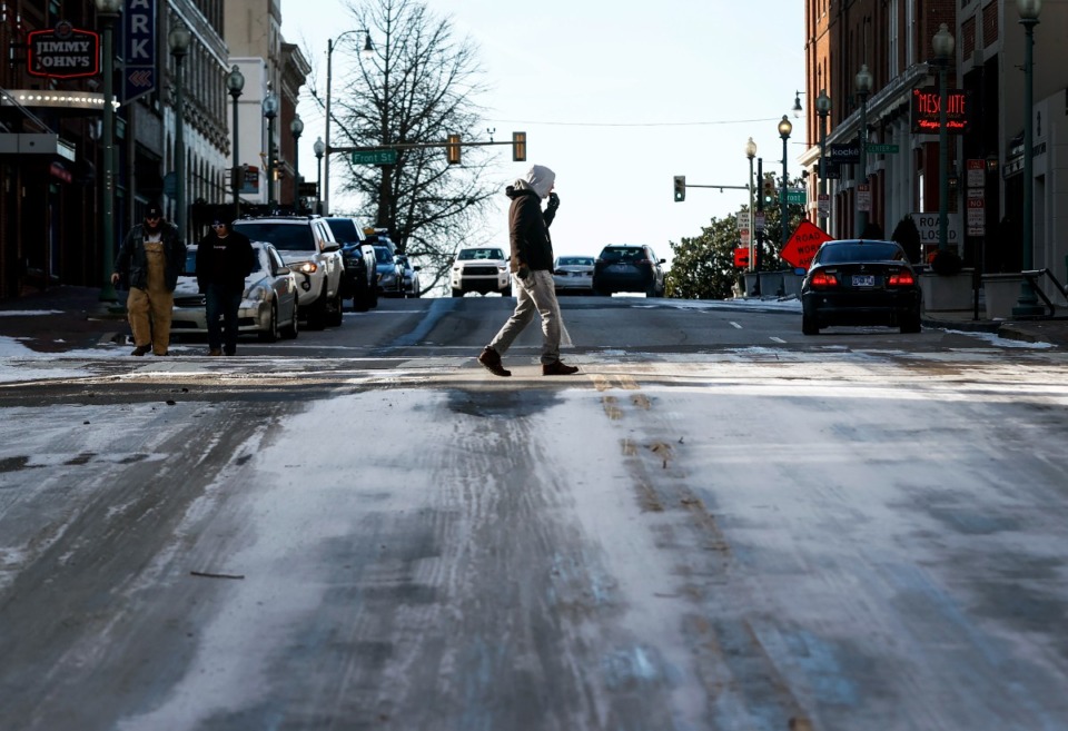 <strong>A man braves the blistering cold temperatures and icy conditions while walking downtown on Friday, December 23, 2022.</strong> (Mark Weber/The Daily Memphian)