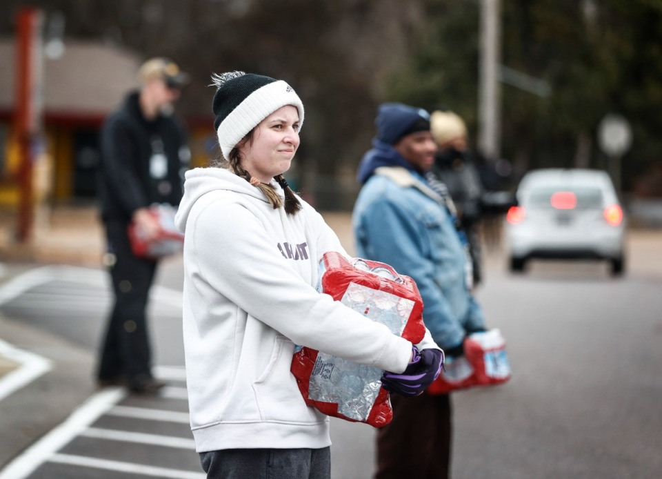 <strong>Volunteers handout cases of bottle water at the Memphis, Light Gas and Water location on East Shelby Drive on Monday, Dec. 26. MLGW customers are under a water boil advisory.</strong> (Mark Weber/The Daily Memphian)