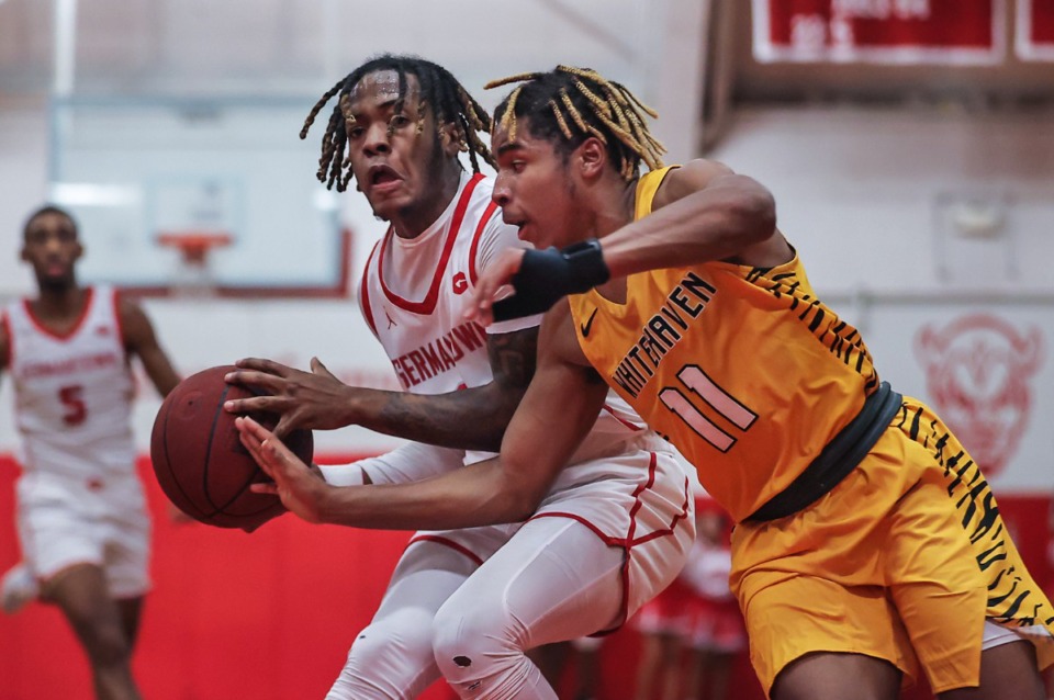 <strong>Whitehaven guard Marrius Harris (11) tries to steal the ball from Germantown guard Jacory Dixon (4) during a Dec. 9, 2022 game.</strong> (Patrick Lantrip/The Daily Memphian)