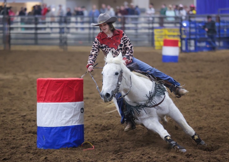 <strong>A rider defies gravity through sheer speed in the barrel-racing competition at the 2022 AutoZone Liberty Bowl Professional Rodeo on Dec. 26, 2022.</strong> (Patrick Lantrip/The Daily Memphian)