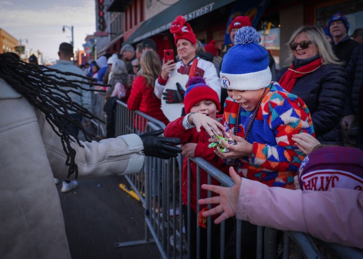 <strong>A young Kansas fan reacts to hitting the candy jackpot during the 2022 AutoZone Liberty Bowl Parade on Beale Street on Dec. 27, 2022.</strong> (Patrick Lantrip/The Daily Memphian)