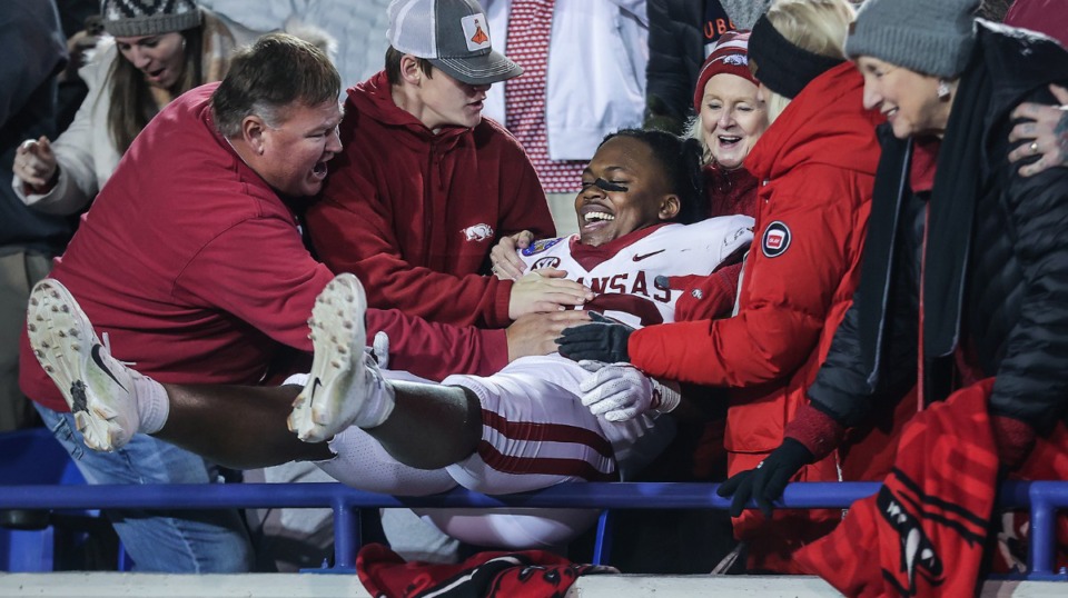 <strong>Arkansas linebacker Jordan Crook (36) leaps into the stands to celebrate with fans after defeating Kansas in the AutoZone Liberty Bowl on Dec. 28, 2022.</strong> (Patrick Lantrip/The Daily Memphian)