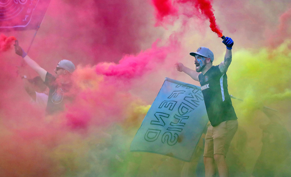 <strong>In a cloud of colored smoke, Alex Hall cheers on Memphis at the start of 901 FC's game against the Charleston Battery on April 27, 2019, at AutoZone Park.</strong> (Jim Weber/Daily Memphian)