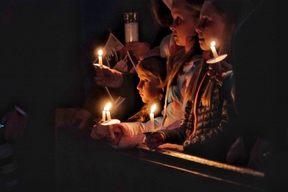 <strong>Candles, symbolic of Jesus&rsquo; arrival in the world, help illuminate a dark and cold church during a temporary power outage on Christmas Eve at St. Michael Church at 3863 Summer Ave.</strong> (Karen Focht/Special to The Daily Memphian)