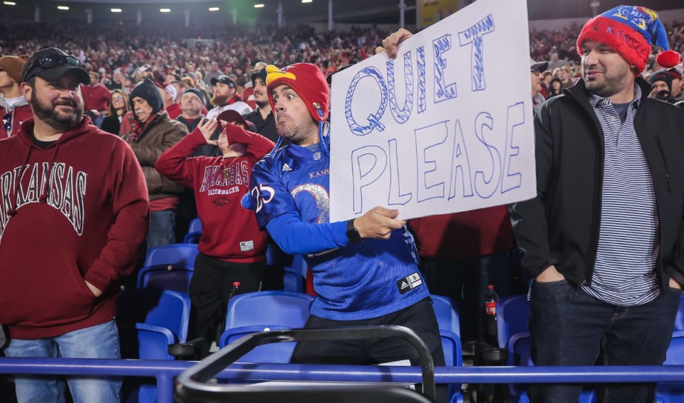 <strong>A Kansas fan sitting in the Arkansas side holds up a sign at a group of opposing fans during AutoZone Liberty Bowl Dec. 28, 2022.</strong> (Patrick Lantrip/The Daily Memphian)