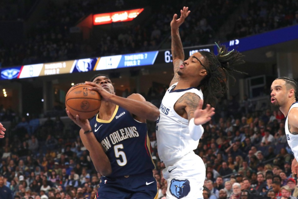<strong>New Orleans Pelicans forward Herbert Jones (5) shoots while defended by Memphis Grizzlies guard Ja Morant, right, during the first half of an NBA basketball game Saturday, Dec. 31, 2022,at FedExForum.</strong> (Nikki Boertman/AP)