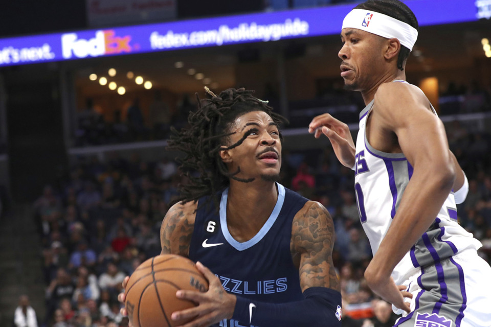 <strong>Memphis Grizzlies guard Ja Morant (12) drives to the basket defended by Sacramento Kings forward KZ Okpala (30) in the game, Sunday, Jan. 1, 2023.</strong> (Nikki Boertman/AP Photo)