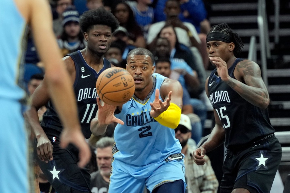 <strong>Memphis Grizzlies' Xavier Tillman (2) passes the ball as his path to the basket is blocked by Orlando Magic's Mo Bamba (11) and Admiral Schofield, right, on Thursday, Jan. 5, 2023, in Orlando, Florida.</strong> (John Raoux/AP)