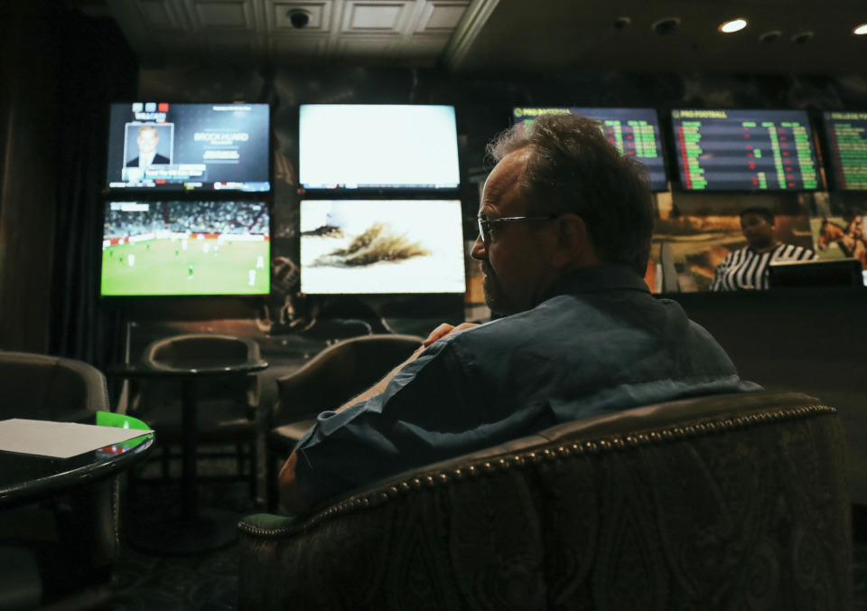 <strong>A visitor to Horseshoe Casino in Tunica, Mississippi, watches television screens as he places bets on football at the casino's sports betting lounge. Sports betting is legal in the state.</strong>&nbsp;<strong>On Tuesday, April 30, legislation setting up an online gambling sports network in Tennessee passed the Senate.</strong> (Houston Cofield/Daily Memphian file)