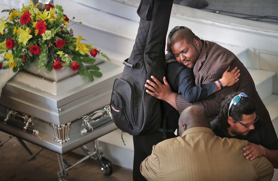 <strong>Joseph Higgins (right) welcomes mourners during a visitation and funeral on Tuesday, April 30, 2019, for his late brother, Omar Higgins, leader of the reggae band Chinese Connection Dub Embassy.</strong> (Jim Weber/Daily Memphian)