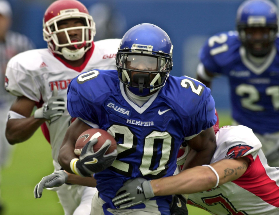 <strong>Memphis' DeAngelo Williams fights through the Houston defense for a 33-yard run during first half Saturday, Oct. 2, 2004, at Liberty Bowl Memorial Stadium in Memphis. The run gave Williams the school's all-time rushing record. He later broke the school's single-game rushing record. Williams was elected to the College Football Hall of Fame Monday.</strong> (AP File Photo/ Mark Weber)