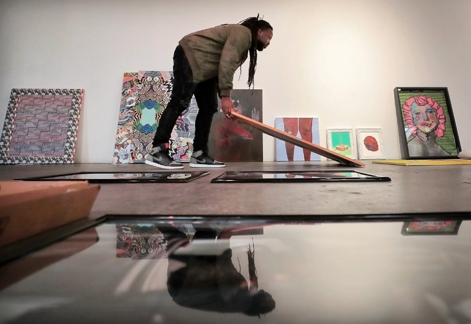 <strong>Jamond Bullock rearranges pieces before installing the "Young, Gifted, and Dope, Episode 2" art show at Marshall Arts on Nov. 16, 2018. The showcase is returning this week after a COVID-induced hiatus.</strong> (Jim Weber/Daily Memphian)