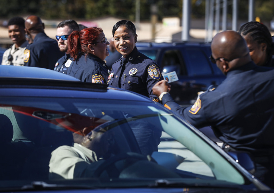 <strong>Memphis Police Chief Cerelyn "C.J." Davis (middle) looks on as officers give away steering wheel locks in October.</strong> (Mark Weber/The Daily Memphian file)