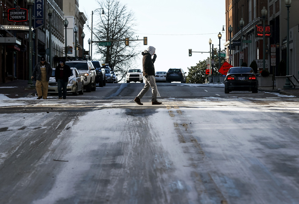 <strong>A man braves the blistering cold temperatures and icy conditions while walking downtown during the 2022 Christmas winter storm.</strong> (Mark Weber/The Daily Memphian file)