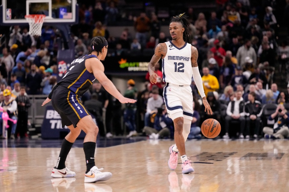 <strong>Memphis Grizzlies guard Ja Morant (12) brings the ball upcourt in front of Indiana Pacers guard Andrew Nembhard, left, during the first half of an NBA basketball game in Indianapolis, Saturday, Jan. 14, 2023.</strong> (AJ Mast/AP)