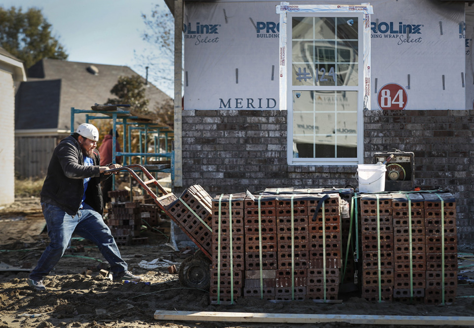 <strong>Brick masons work on house for Meridian Premier Homes in Walls, Mississippi. Walls issued 43 single-family housing permits in 2022.</strong> (Mark Weber/The Daily Memphian file)