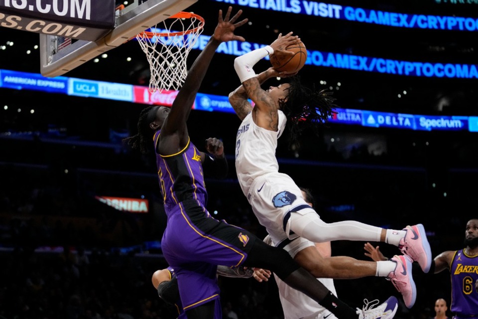<strong>Memphis Grizzlies guard Ja Morant (12) flies over Lakers forward Wenyen Gabriel (35) on Friday, Jan. 20, 2023, in Los Angeles.</strong> (Ashley Landis/AP)
