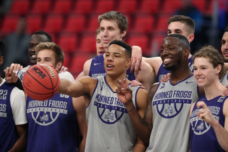 <strong>TCU guard Desmond Bane (center) holds a basketball next to forward JD Miller (second from right), as they pose with teammates after practicing for an NCAA men's college basketball tournament first-round game, Thursday, March 15, 2018, in Detroit.</strong>&nbsp;(Carlos Osorio/AP file)