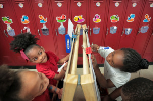 <strong>Madison Clark (left), Ayanna Hughes, La'kiya Carr and Jaylen King work at an easel where they color their reading assignment in Thomas Denson's Pre-K class at Cherokee Elementary School. More than three in four Shelby County elementary students, and four in five middle and high school students, read below grade level.</strong>&nbsp;(Jim Weber/Daily Memphian)
