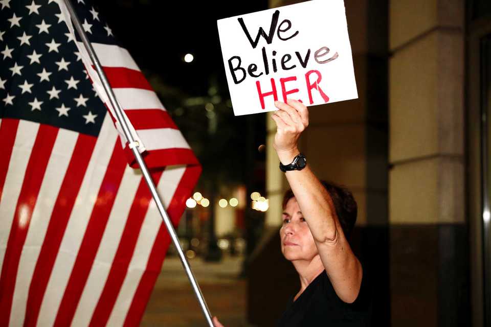 <strong>Mary Green, 58, joins protesters at the corner of Main Street and Peabody Place Monday, Oct. 8, to protest the confirmation of Judge Brett Kavanaugh as a U.S. Supreme Court justice. Protesters shared personal accounts of sexual assault and voiced their support for Dr. Christine Blasey Ford.</strong> (Houston Cofield/Daily Memphian)
