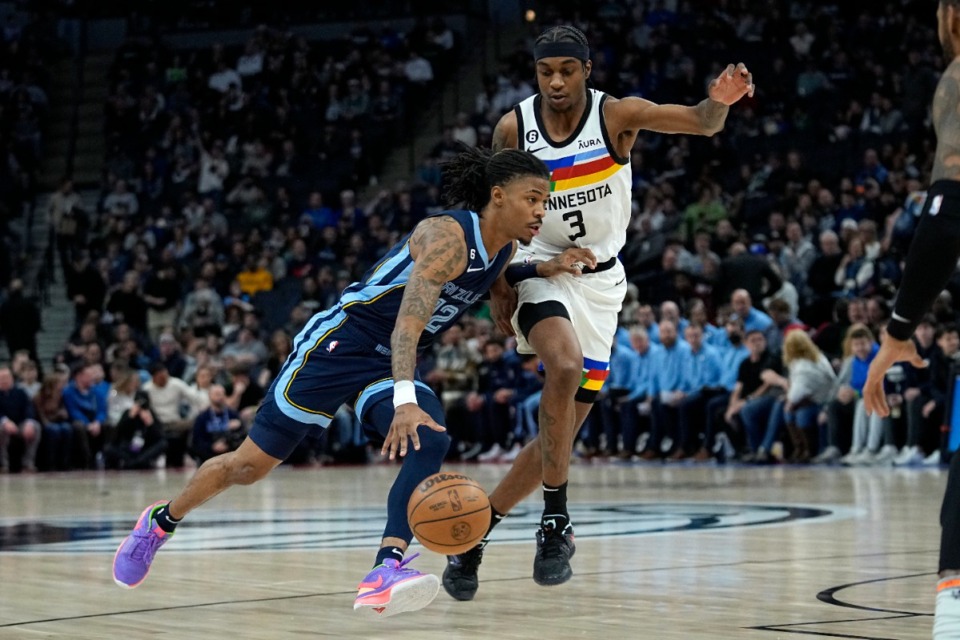 <strong>Memphis Grizzlies guard Ja Morant works towards the basket while defended by Minnesota Timberwolves forward Jaden McDaniels (3) on Friday, Jan. 27, 2023, in Minneapolis.</strong> (Abbie Parr/AP)