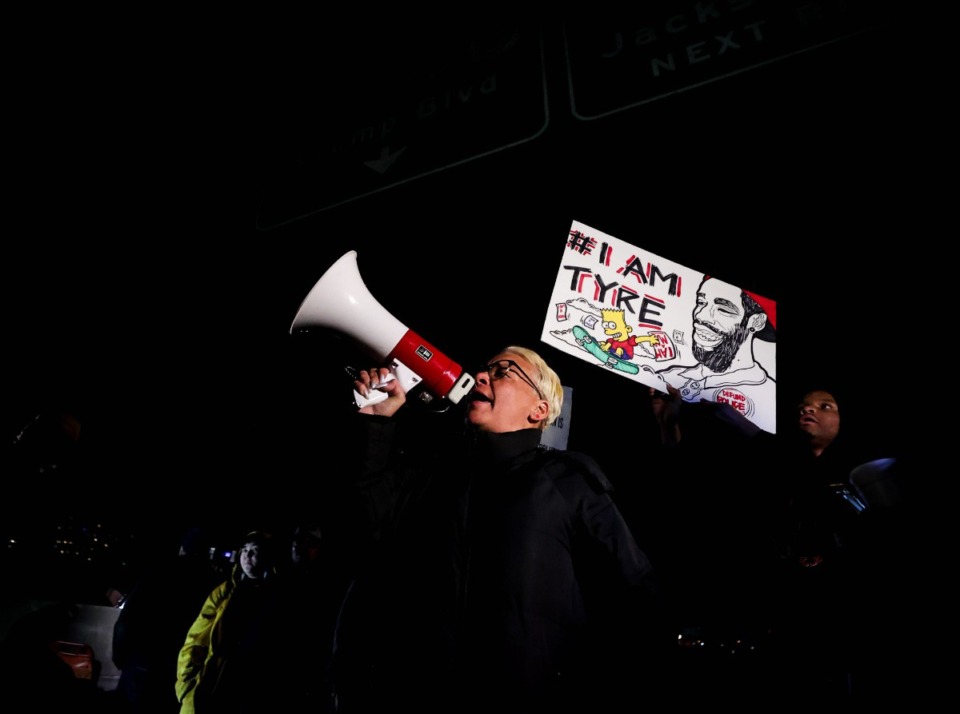 <strong>Protesters give instructions underneath the I-55 highway signs while blocking bridge traffic across the Mississippi River on Jan. 27, 2023.</strong> (Patrick Lantrip/The Daily Memphian)