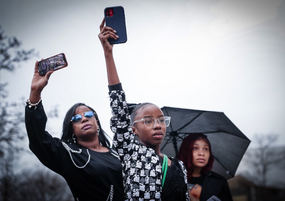 <strong>Tracey Barnes (left), along with her daughters Tekeria Blue (center) and Taylin Barnes, livestream speakers during a march for Tyre Nichols in Downtown Memphis Jan. 28, 2023.</strong> (Patrick Lantrip/The Daily Memphian)