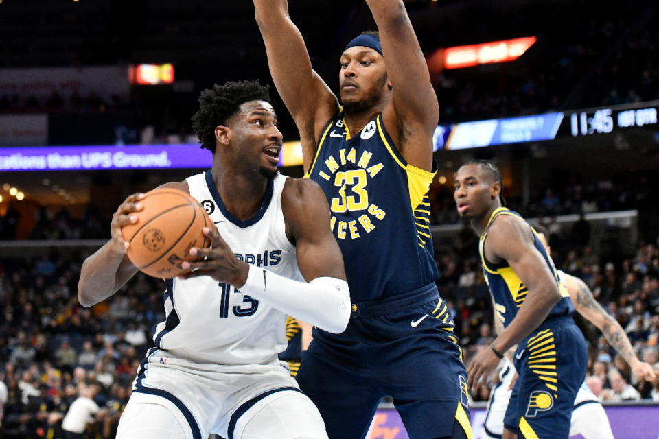<strong>Memphis Grizzlies forward Jaren Jackson Jr. (13) handles the ball against Indiana Pacers center Myles Turner (33) in the first half of an NBA basketball game Sunday, Jan. 29, 2023, in Memphis, Tenn.</strong> (AP Photo/Brandon Dill)